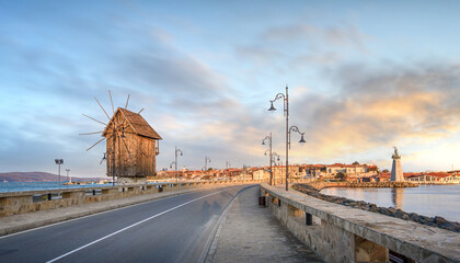 Fototapeta premium Old wind mill at sunset in the old town of Nessebar in Bulgaria. Nesebar is one of the major seaside resorts on the Bulgarian Black Sea Coast. UNESCO heritage site 
