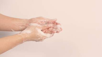 Fototapeta premium Hand wash gesture with foaming hand soap on white background.copy space