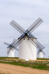Fototapeta na wymiar three whitewashed traditional Spanish windmills on the plains of La Mancha