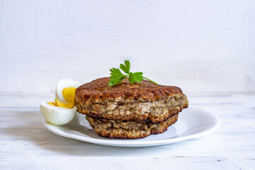Liver cutlets on white background with copy space.