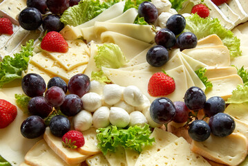 buffet of cheese slices and fruits