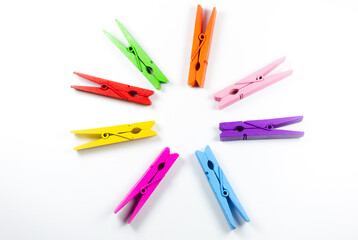 Colorful wooden clothespins on white background. Close up, copy space.