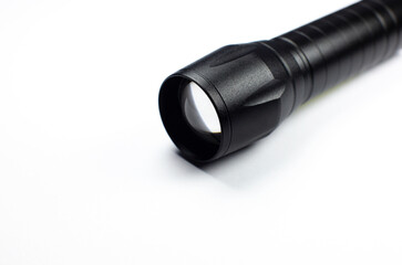 Black Flashlight on the white background. Close up.