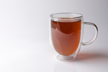 glass thermo mug with black tea on a white background
