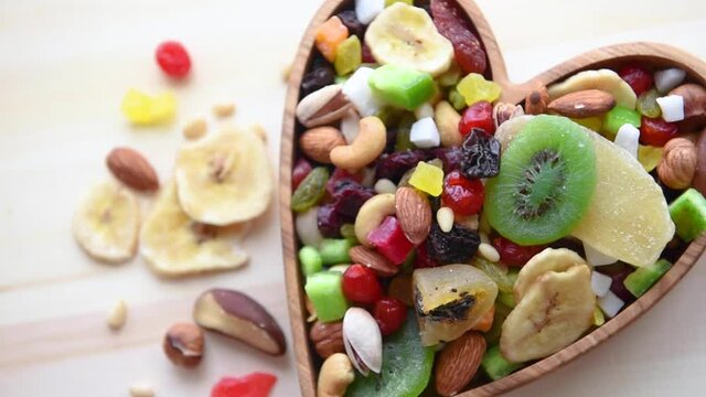 Circular rotation of bowls with different dried fruits and nuts
