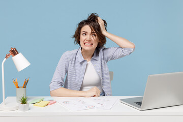 Young troubled stressed employee business woman 20s wear casual shirt sit work at white office desk...