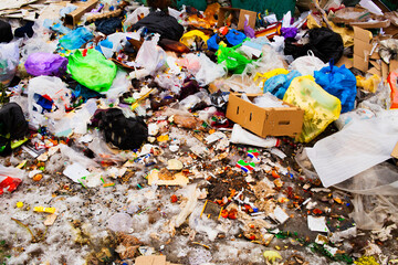 Garbage pile in landfill and abundance of waste, trash and pollution of plastic bottles and bags on...