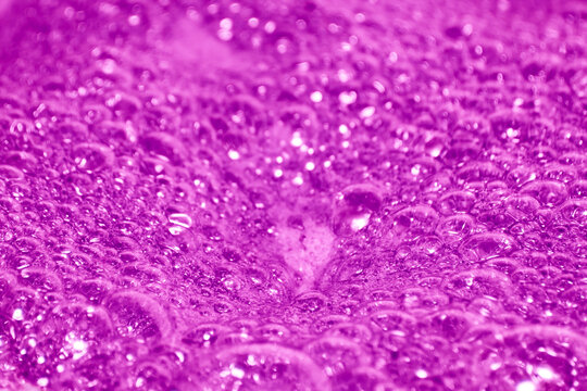 Pink foam. Foam texture as background. Background and texture concept. Close up of bubbling pink foam