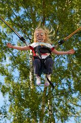 children masked as clown jumping in the air