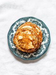 Banana pancakes on a light background, top view
