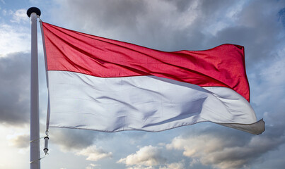 Indonesia flag waving against cloudy sky