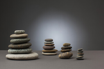 Fototapeta na wymiar Stones standing in balance on grey background