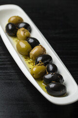 Black and green olives on black