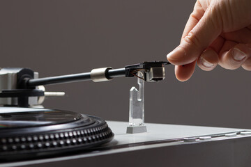 Vintage record player while recording, the record spins and music plays. Gramophone macro close-up photo.
