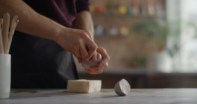 Ceramist kneads a colored pieces of clay to make a nerikomi pottery at the workshop, potter at work, craftsmanship of making goods from clay, 4k 60p Prores HQ 10 bit