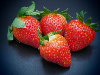 strawberries on black background