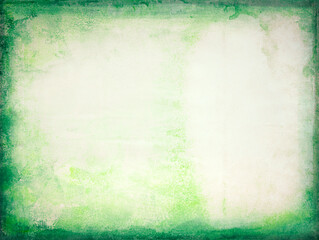 Close-up of old yellow paper sheet with green edges, texture background