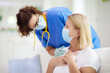 Fototapeta premium Doctor examining sick patient. Ill woman in clinic