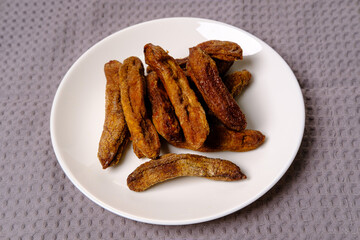 dried bananas on a white plate
