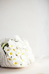 Bouqet of White Chrysanthemum Fresh bouqet of white flowers above white wall. Vertical photo. Space for text