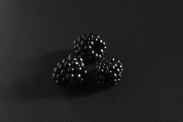 three blackberry on black background