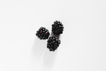 three blackberries on white background