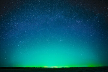 Beautiful Night Sky Glowing Stars Background Backdrop With Colorful Sky Gradient. Colourful Night Starry Sky In Blue Aquamarine Green Colors. Dark Ground. Copy Space