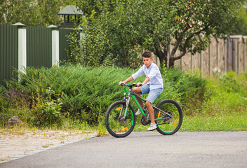 Obraz na płótnie Canvas Teenage boy is riding on a bicycle
