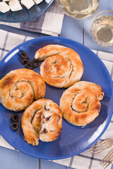 Pastry swirls with cheese and olive filling.
