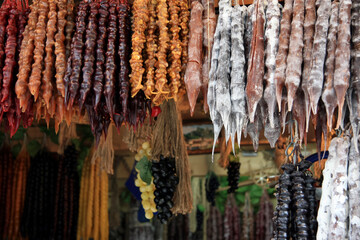Churchkhela of different types in the assortment of the Tbilisi bazaar and grapes