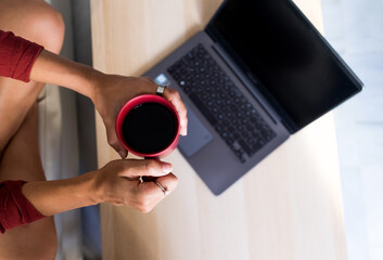 Woman hands holding a cup of coffee