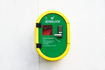 Defibrillator AED on wall in public space for emergency heart resuscitation - obrazy, fototapety, plakaty