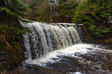 Cascade falls over mossy rocks