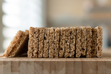 Dry crispbread on a wooden board, shallow depth of field.
