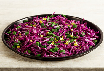 Red cabbage salad with fresh green onions dill and sprouted mung beans on a white background. Vegetarian dish. Top view. Concept of healthy eating.