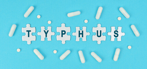 On a blue background, there are pills and puzzles with the inscription - TYPHUS
