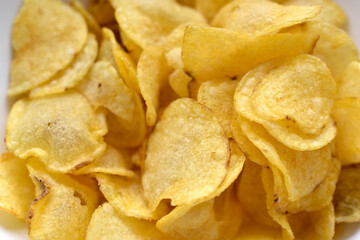 Yellow beautiful delicious chips close up in a restaurant