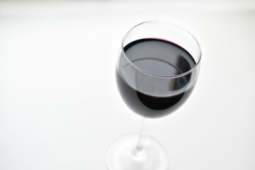 Large glass of red wine on a white background