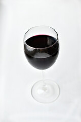 Large glass of red wine on a white background