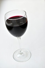 Large glass of red wine on a white background