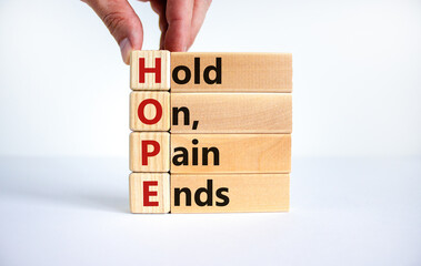 HOPE, hold on, pain ends symbol. Wooden cubes with words 'HOPE, hold on, pain ends. Beautiful white...