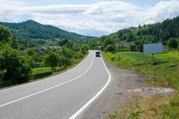 highways in the mountains against the background of the sunny sky and the white clouds