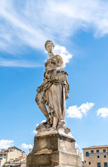 Fototapeta na wymiar Statue of Spring, sculpted by Italian artist Pietro Francavilla in early 17th century on the Santa Trinita Bridge in Florence city center, Tuscany, Italy