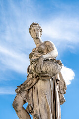 Fototapeta na wymiar Statue of Spring, sculpted by Italian artist Pietro Francavilla in early 17th century on the Santa Trinita Bridge in Florence city center, Tuscany, Italy