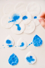 Let's make the rain. Boy coloring drop shape cotton pads. 5 minute crafts for children activities....