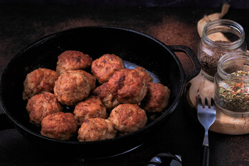 Easy Homemade Meatballs in a frying pan on dark background.  