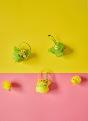 Easter eggs on the yellow -pink background. Happy Easter. Holiday concept. Focus on chicken on yellow background.