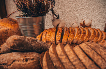 Gold rustic crusty loaves of bread and buns. Bakery concept. Focus on bread.