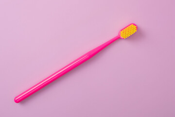 Dental toothbrush isolated on pink background. Dental hygiene and health concept.