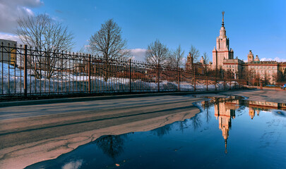 Spring sunny landscape of famous university in Moscow with pool reflection